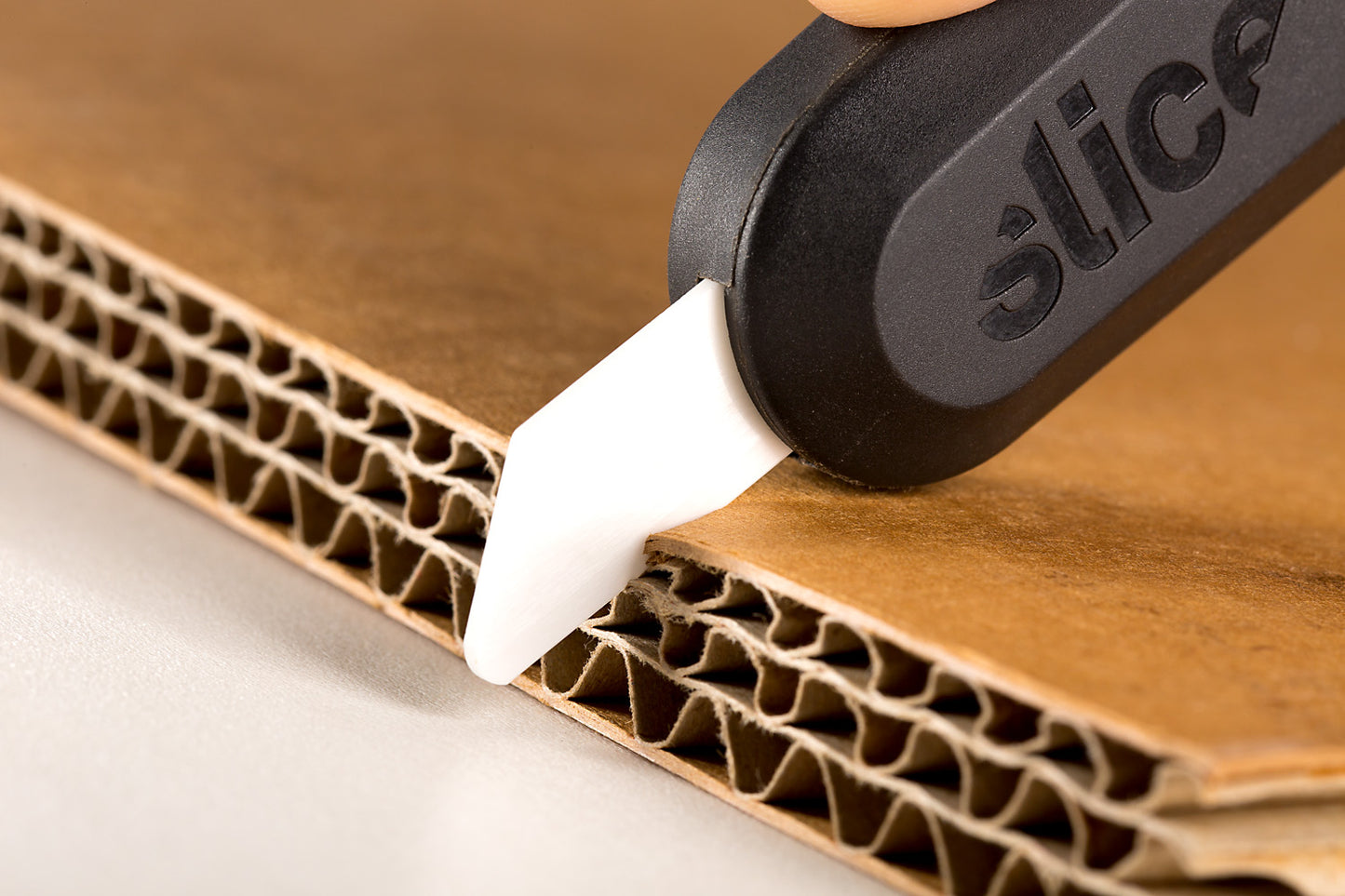 Slice Ceramic Utility Knife Blades (Rounded Tip) In Use Cutting Cardboard - DaltonSafety